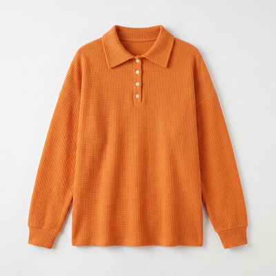 Orange waffle-knit sweater flat lay