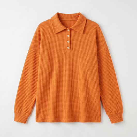 Orange waffle-knit sweater flat lay